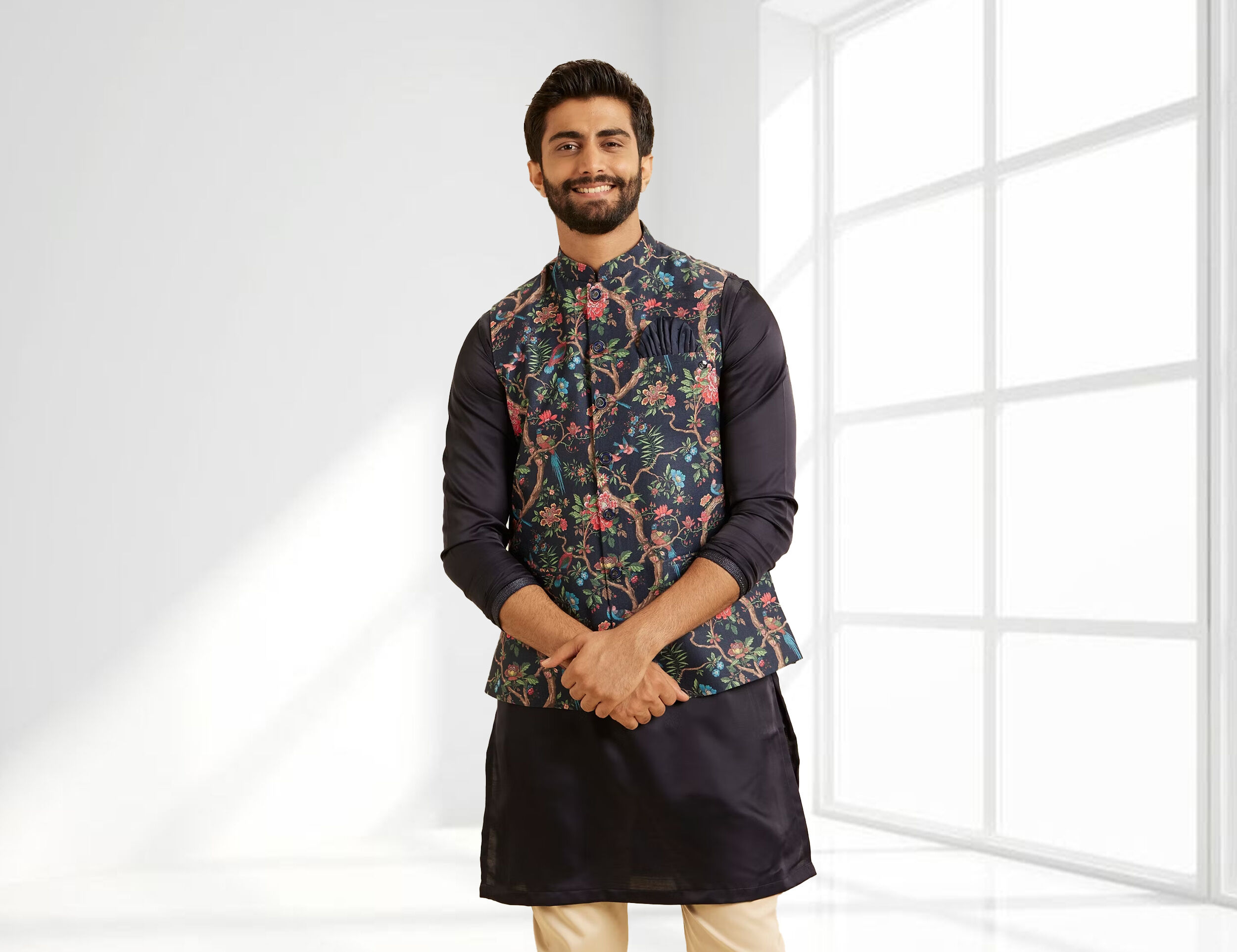 Man wearing a navy kurta with floral printed Nehru jacket, styled for festive and wedding occasions.
